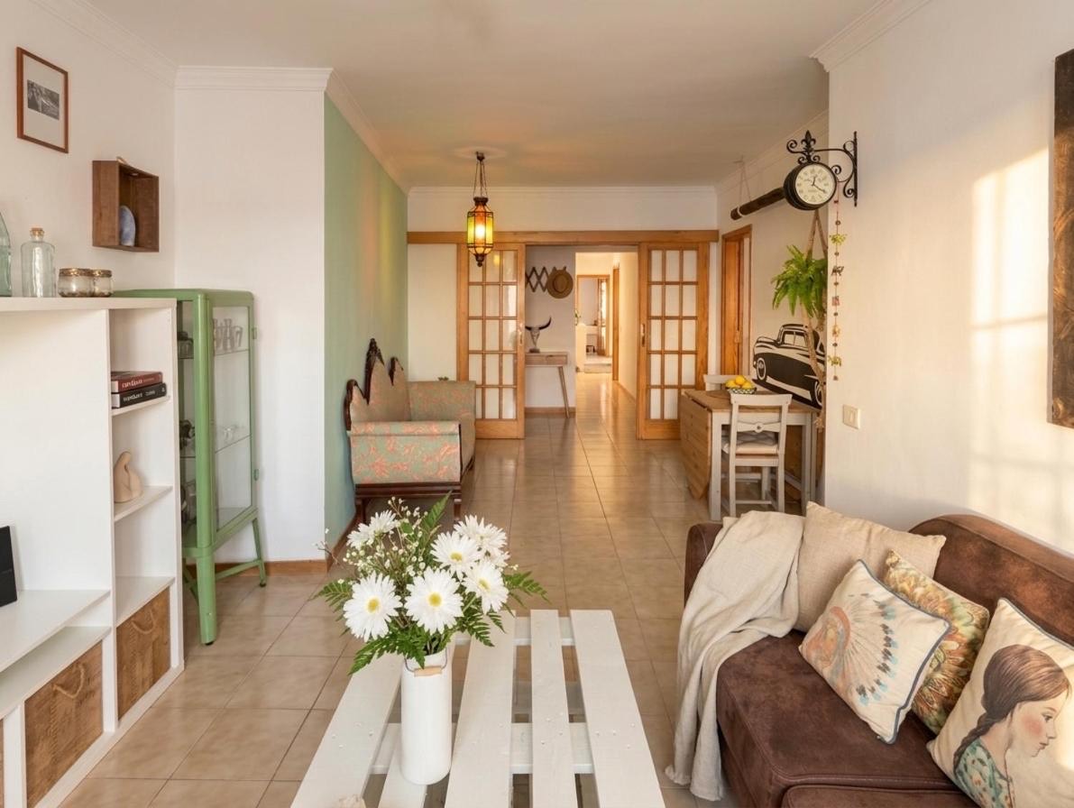 Living room with a sofa and a view down the hallway