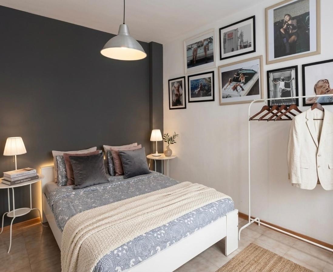 Double bedroom with a grey feature wall and framed photographs
