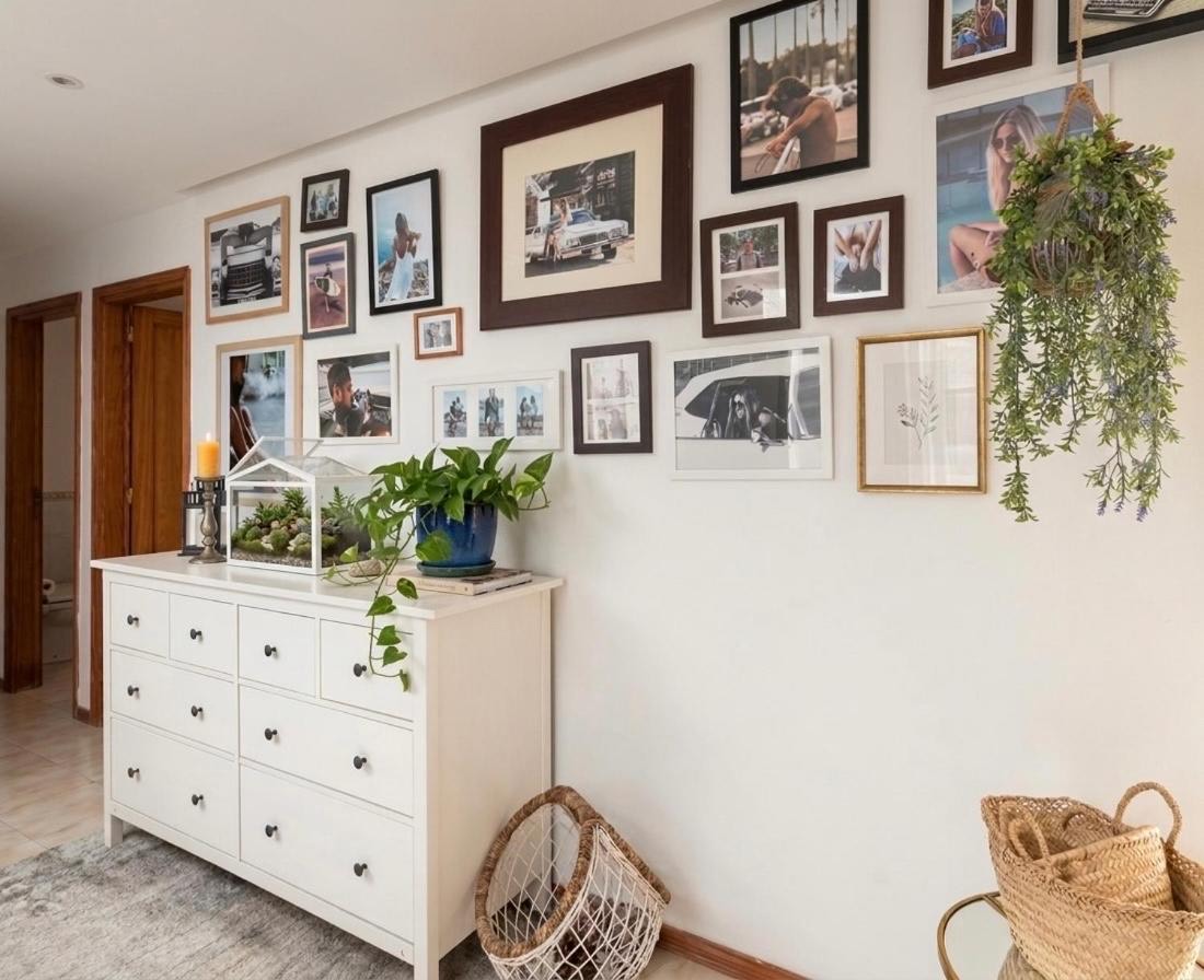Hallway with a chest of drawers and a wall of framed photographs