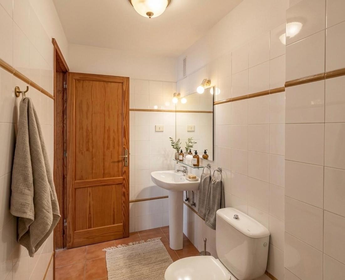 Bathroom with a wooden door and towel hooks